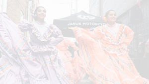 Two Hispanic women dancing on street