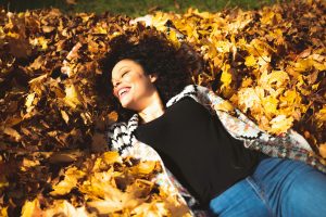 Happy girl in fallen leaves